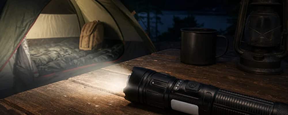 A Fuyao flashlight lighting a tent pitched by a lake after dark